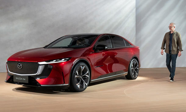 Der Mazda6e (2025) statisch von schräg vorne mit AUTO ZEITUNG-Redakteur Guntram Fiala.