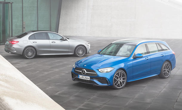 Die Mercedes C-Klasse steht als T-Modell und Limousine nebeneinander vor einem modern gestalteten Gebäude.