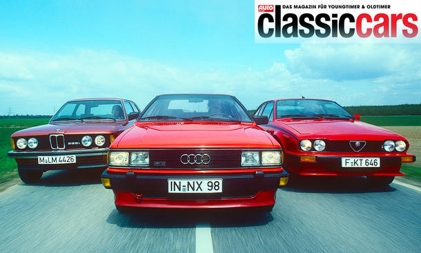 Der BMW 323i/Audi GT 5E/Alfa GTV 2.0 fahrend von vorne fotografiert. 